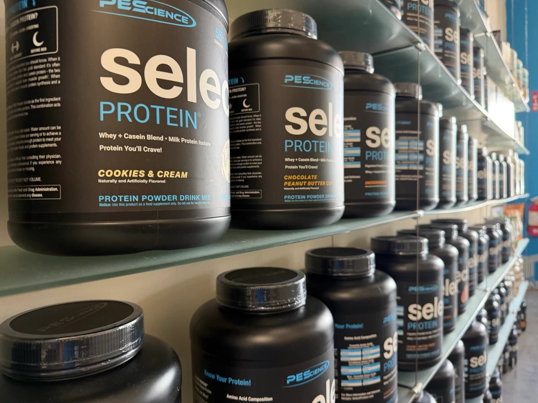 PEScience protein powders stocked on the shelves at Nutrition Elite